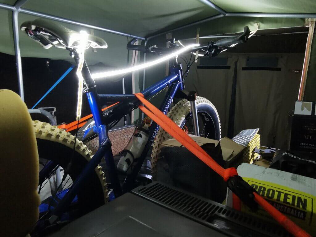 Breaking the Cycle Across Australia 2023 picture of Kate's bicycle in the trailer with a string of lights attached