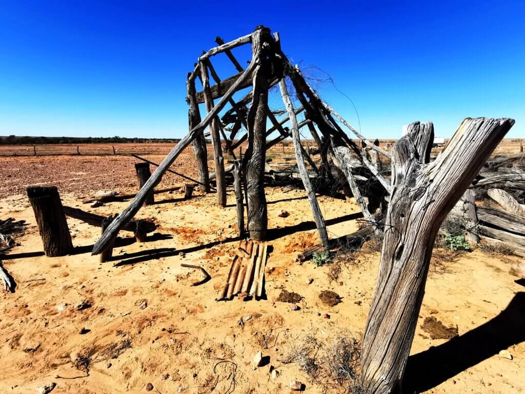 More of the ruins with a few remaing wooden posts sticking out of the ground