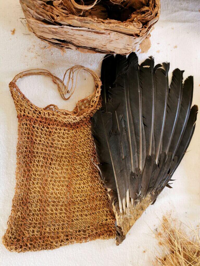 Hand dyed basket and feathers which were bound together so they could be used as a fan