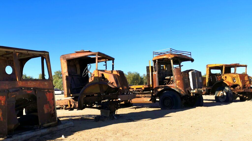 A row of very sorry-looking vintage trucks that worked the Birdsville Track are on display at Mungerannie
