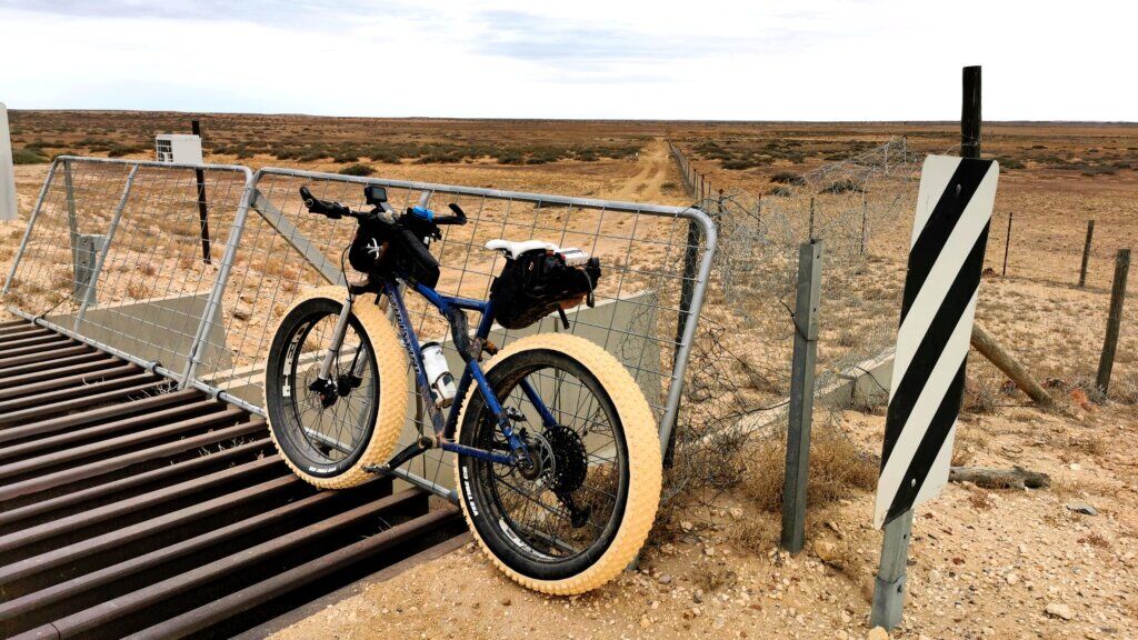 Stopping at the Dog Fence. Bike propped up