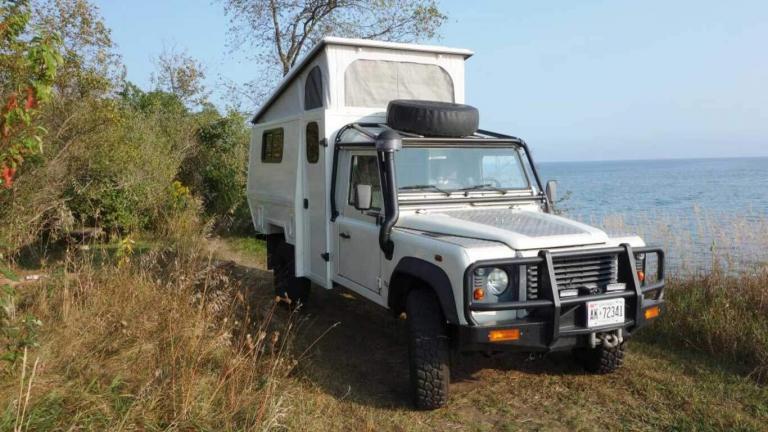 low gear land rover defender 130 with pop top open