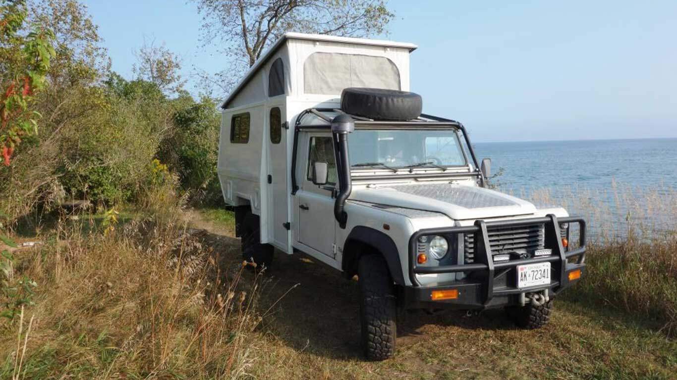low gear land rover defender 130 with pop top open