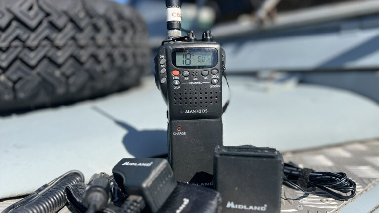 Midland Alan 42DS handheld CB radio sitting on the wing of a Land Rover Series 2A