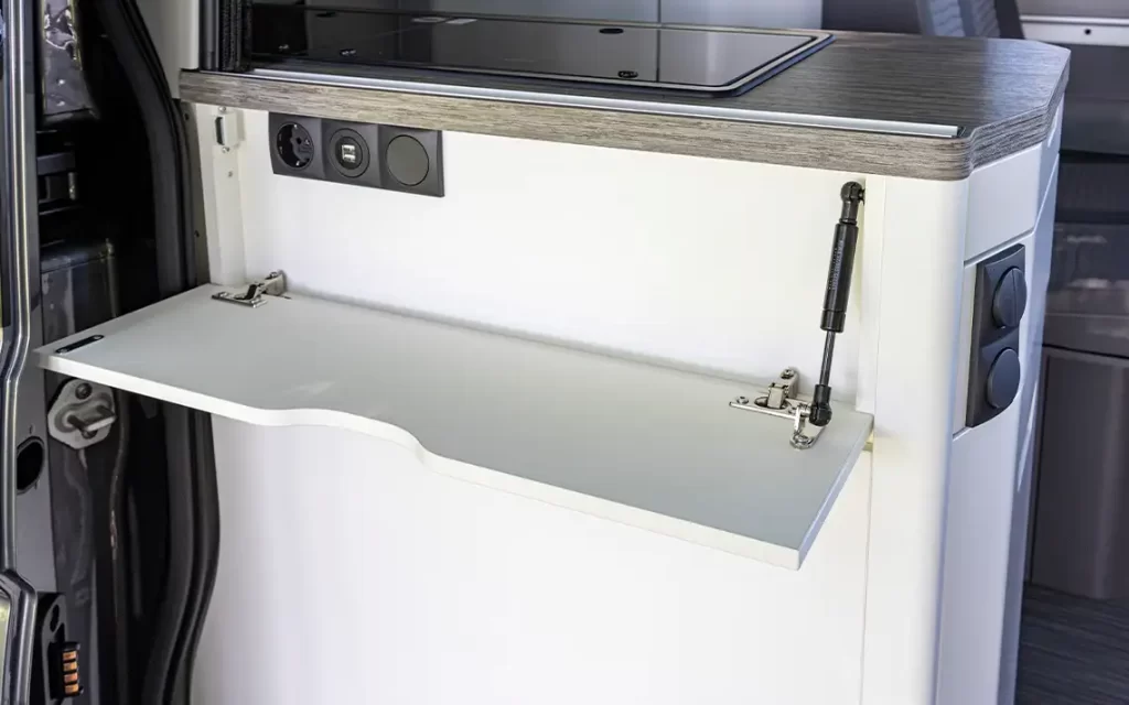 Practical fold down shelf on the rear of the kitchen block with power sockets