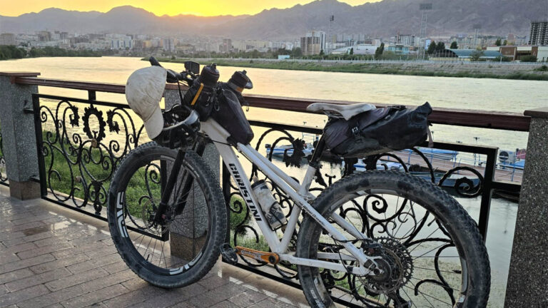 Kate's bike parked on a blacony overlooking the river in the old part of Khujand