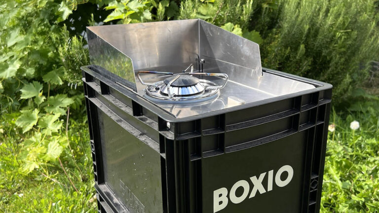 boxio coo camping gas stove outside in front of rosemary bush
