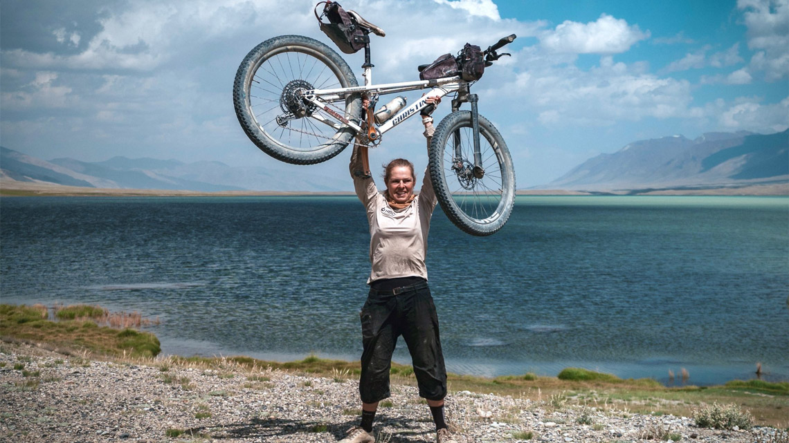 kate holding up her bike over her head