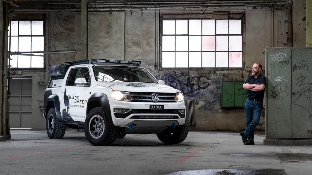 Thomas standing next to his VW Amarok